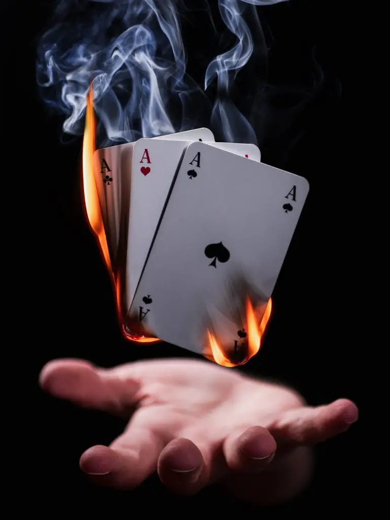 burning playing cards levitate